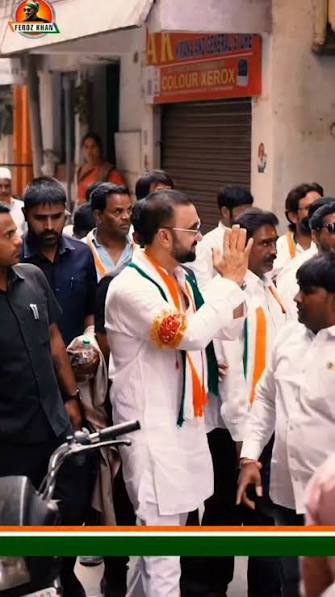 Mohammed Feroz Khan greeting supporters during a street walk in Nampally