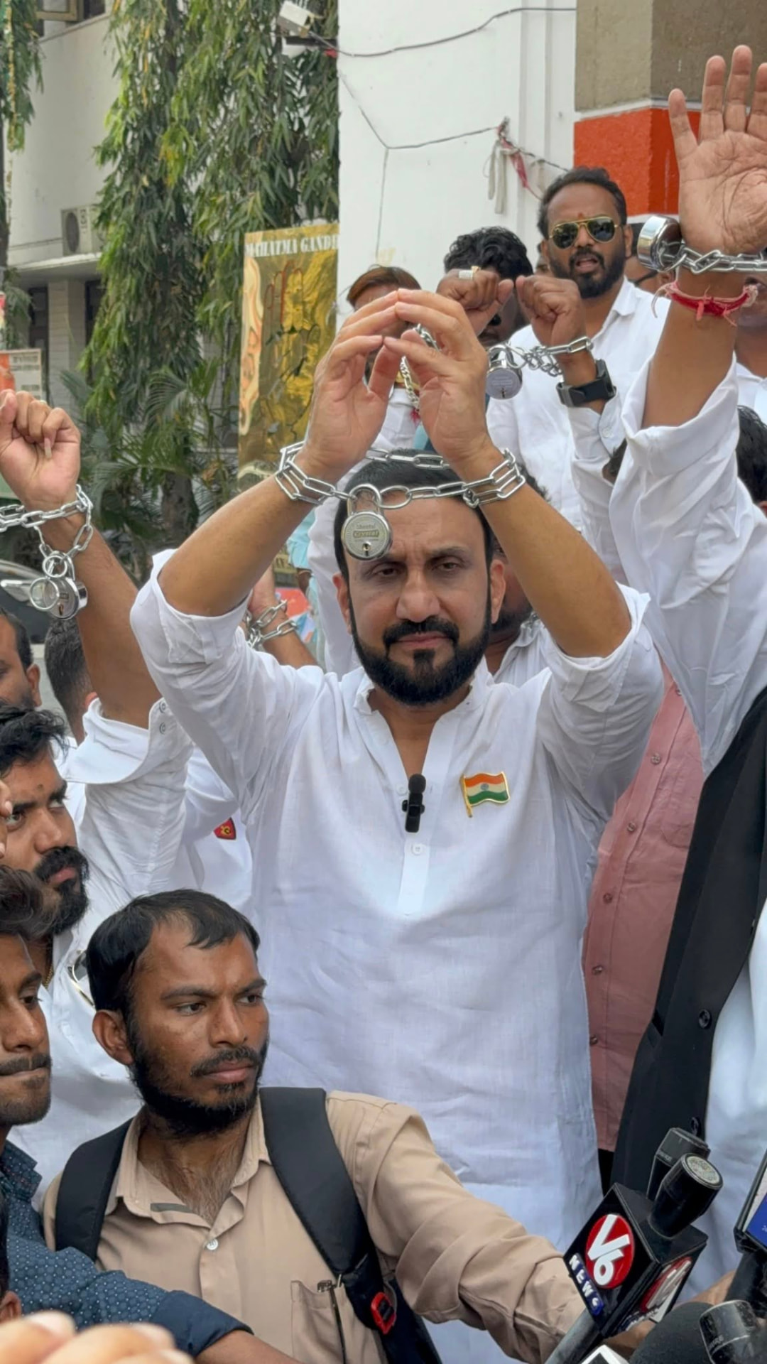 Mohammed Feroz Khan leading a chained-hands protest before the media