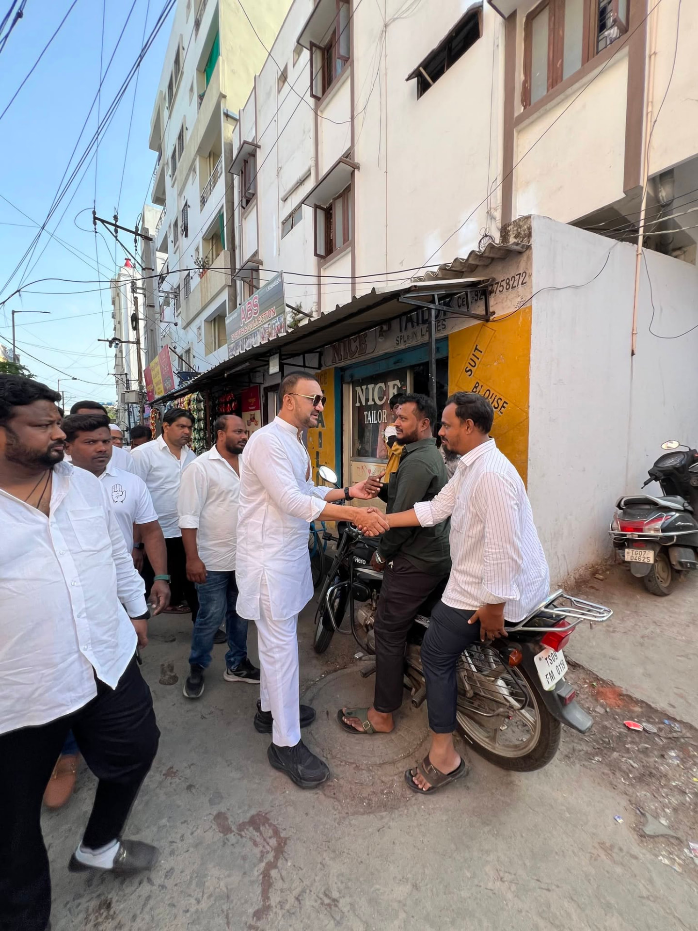 Mohammed Feroz Khan meeting shopkeepers during door-to-door outreach